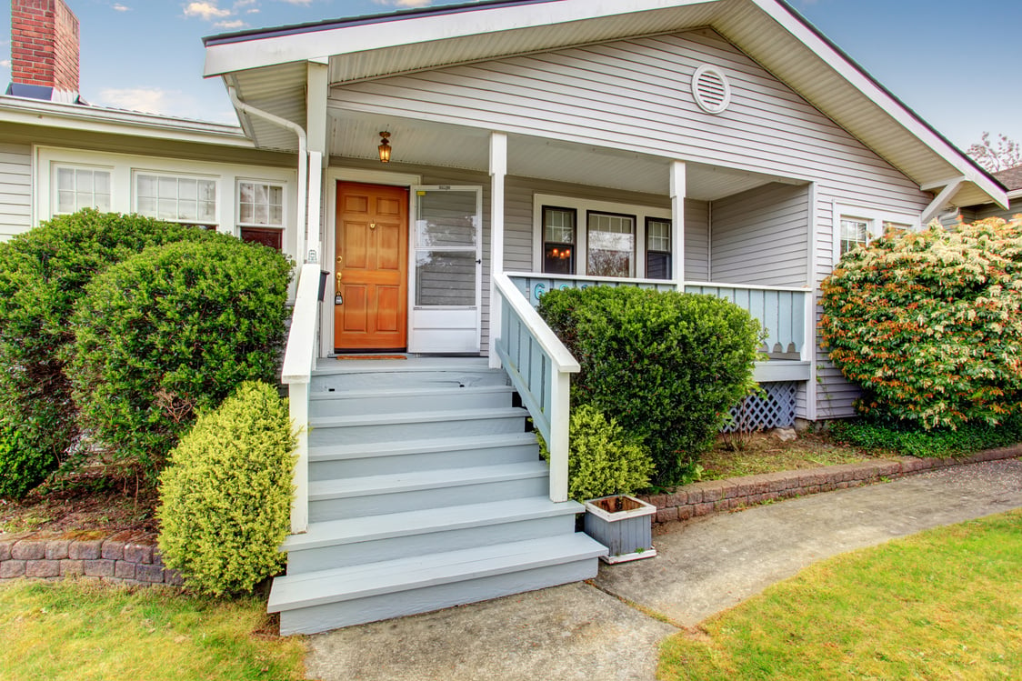 Small American home with light exterior and white trim.